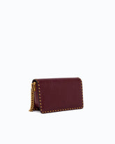 Small Love One Slouchy crossbody bag in leather with studs - Pink | Pinko